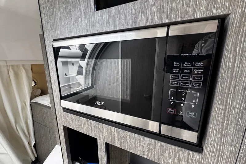 Slide: The Image of Built-in microwave in 2022 Monterey 295 Sport Yacht interior. - 35