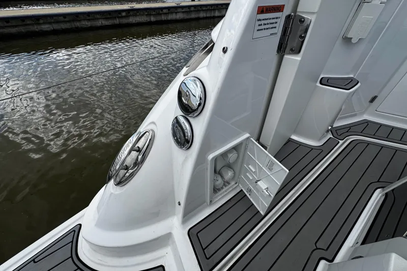 Slide: The Image of 2022 Monterey 295 Sport Yacht deck with storage compartment and sleek design. - 36