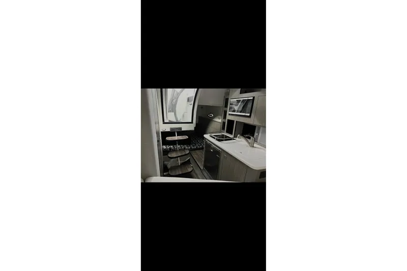 Slide: The Image of Interior of 2022 Monterey 295SS Super Sport boat, featuring modern kitchen amenities. - 17