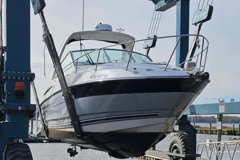 Slide: The Image of 2022 Monterey 295SS Super Sport boat lifted by crane at marina. - 8