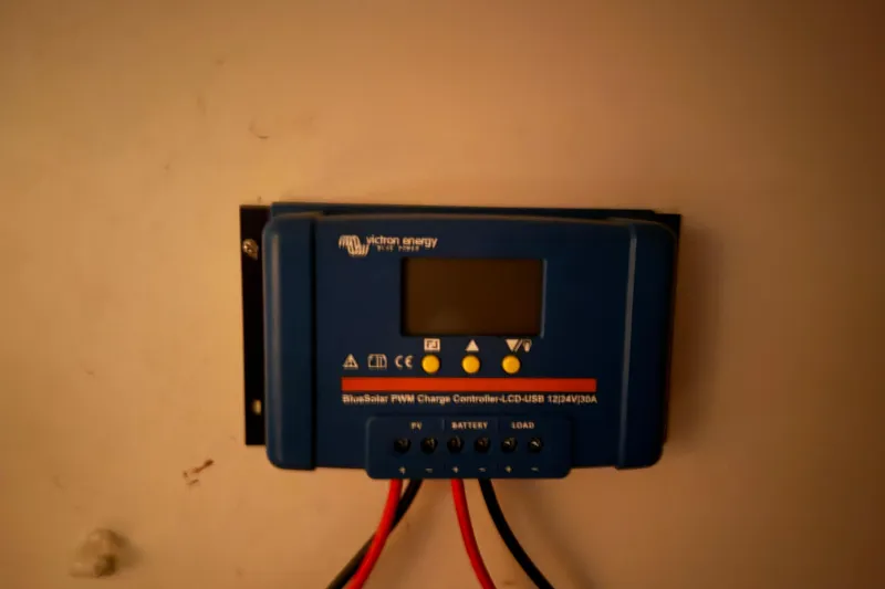 Slide: The Image of Blue Victron Energy charge controller on wall, Tartan 3500 model, year 2000. - 19