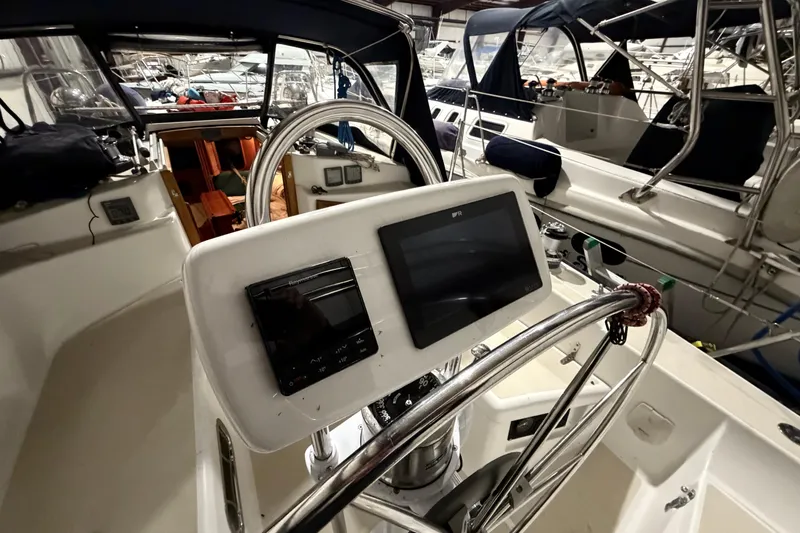 Slide: The Image of Cockpit of a 2000 Tartan 3500 sailboat with navigation equipment and steering wheel. - 26