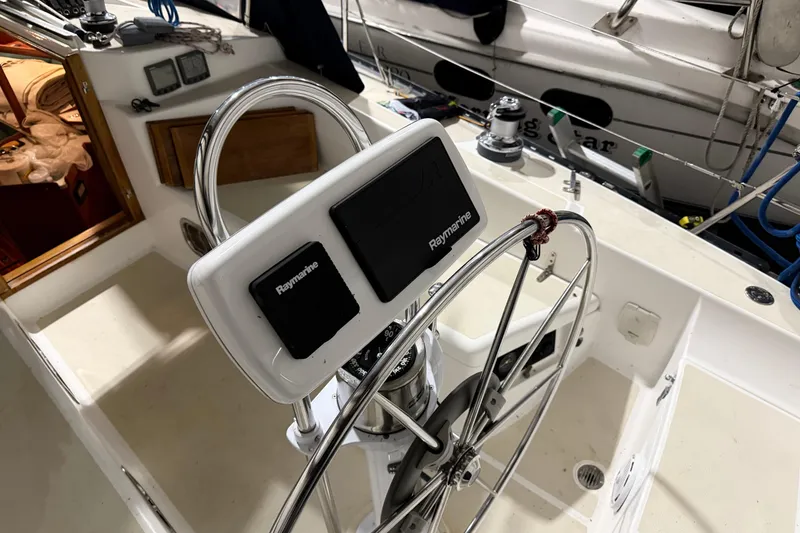Slide: The Image of Steering wheel and navigation equipment on 2000 Tartan 3500 sailboat deck. - 27