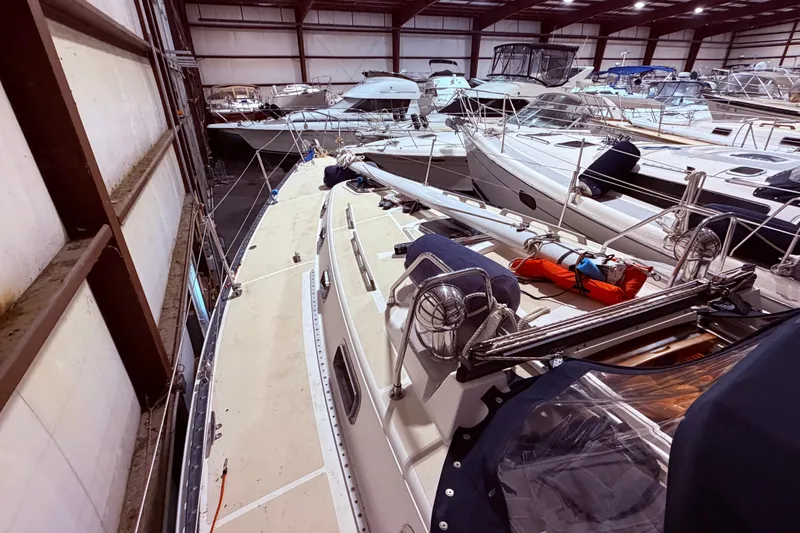 Slide: The Image of Indoor storage of a 2000 Tartan 3500 sailboat among other vessels in a marina. - 29