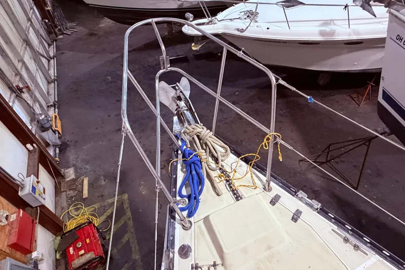 Slide: The Image of Bow of a 2000 Tartan 3500 sailboat in a storage facility, with ropes and equipment. - 30