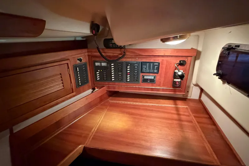 Slide: The Image of Wooden navigation station with control panels in a 2000 Tartan 3500 sailboat interior. - 4