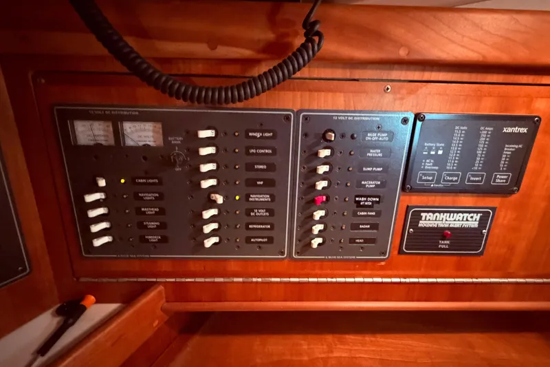 Slide: The Image of Electrical control panel on a 2000 Tartan 3500 yacht, featuring various switches and gauges. - 6