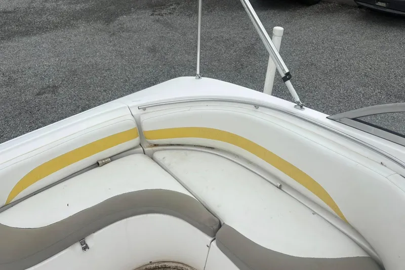Slide: The Image of Bow seating area of a 2004 Mariah DX213 boat with white and yellow upholstery. - 2