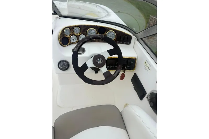 Slide: The Image of Steering console of a 2004 Mariah DX213 boat with gauges and controls. - 3