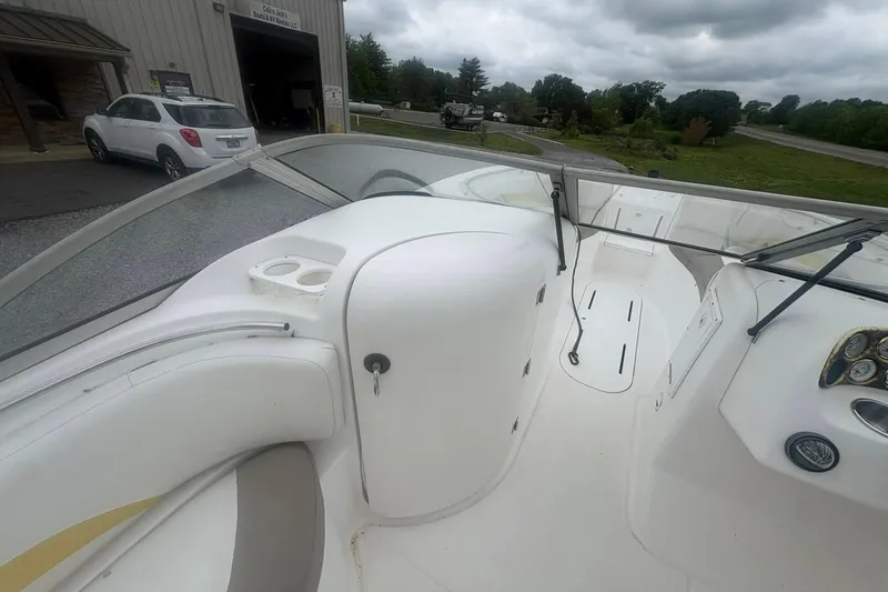 Slide: The Image of Interior view of a 2004 Mariah DX213 boat, showcasing seating and dashboard. - 4