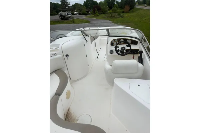 Slide: The Image of 2004 Mariah DX213 boat interior with steering wheel and seating area. - 5