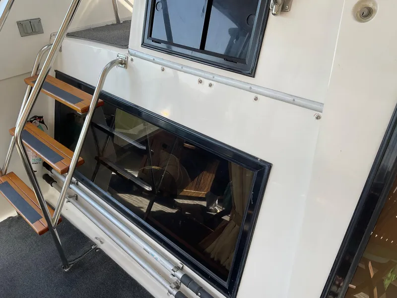 Slide: The Image of 1990 Ocean Alexander 440 Sundeck CPMY with wooden steps and window. - 10