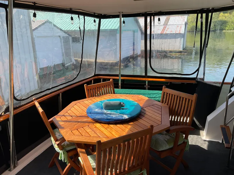 Slide: The Image of Ocean Alexander 440 Sundeck 1990 with wooden table and chairs on deck. - 14