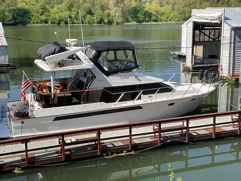 Slide: The Image of 1990 Ocean Alexander 440 Sundeck CPMY docked on a serene river. - 3