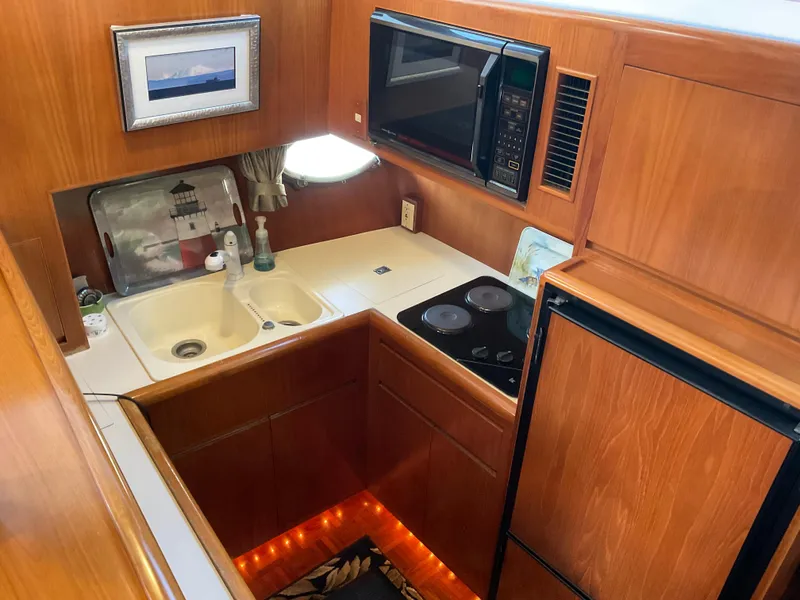 Slide: The Image of 1990 Ocean Alexander 440 Sundeck CPMY kitchen with wood paneling. - 30