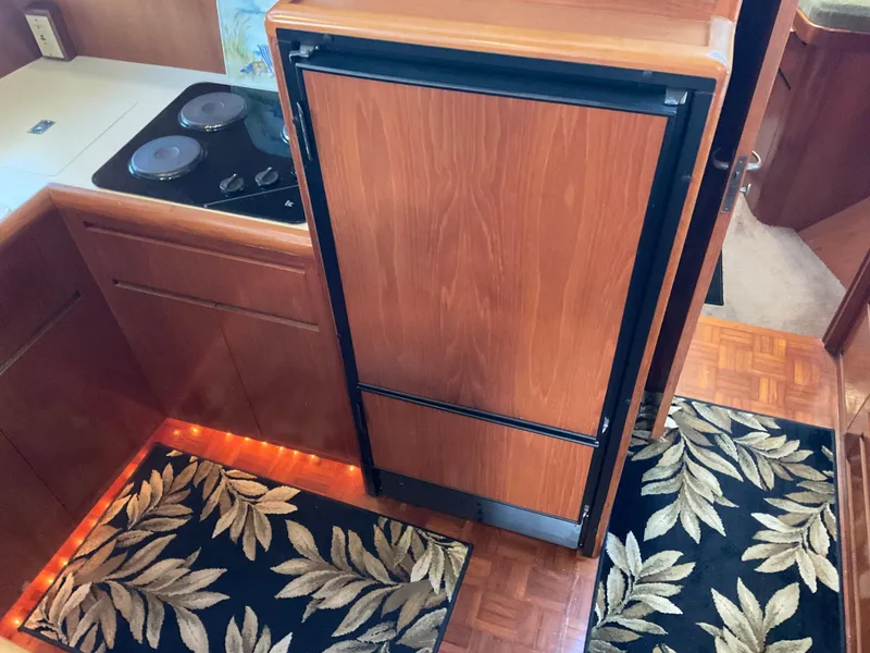 Slide: The Image of 1990 Ocean Alexander 440 Sundeck CPMY kitchen area with wood cabinetry. - 33