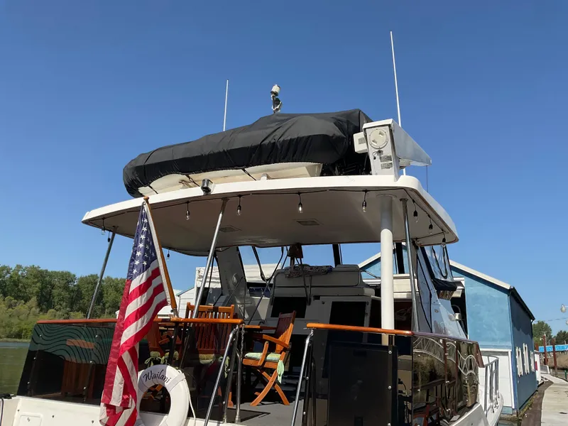 Slide: The Image of 1990 Ocean Alexander 440 Sundeck CPMY with American flag, docked. - 4