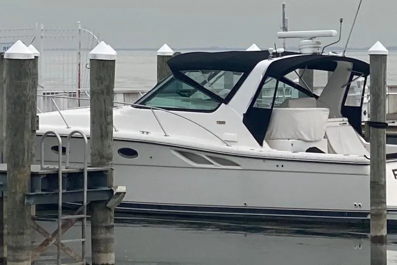 Slide: The Image of 2000 Tiara Yachts 3500 Open docked, featuring sleek design and black canopy. - 1