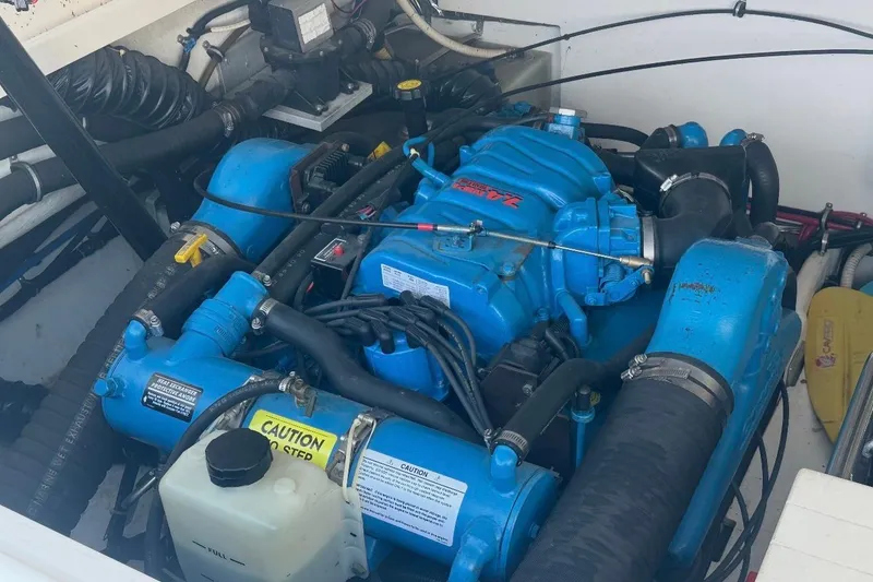Slide: The Image of Engine compartment of a 2000 Tiara Yachts 3500 Open, featuring a blue marine engine. - 14