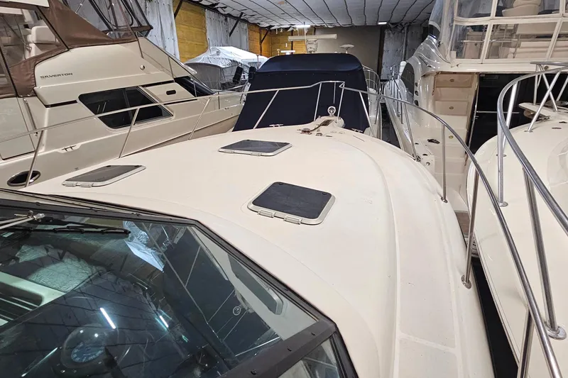Slide: The Image of 2000 Tiara Yachts 3500 Open in storage, surrounded by other boats. - 15