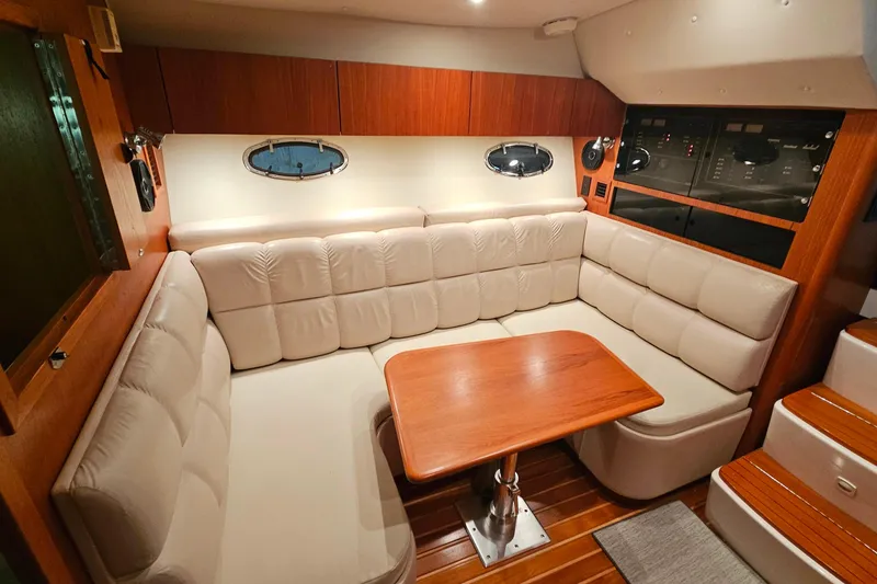 Slide: The Image of Luxurious interior of 2000 Tiara Yachts 3500 Open with plush seating and wooden table. - 25