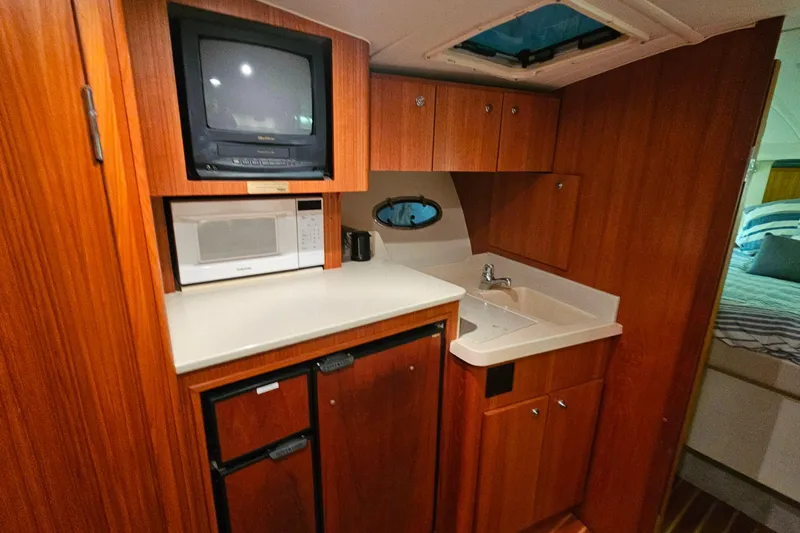 Slide: The Image of Control panel of a 2000 Tiara Yachts 3500 Open, featuring AC system switches and gauges. - 28