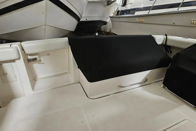 Slide: The Image of 2000 Tiara Yachts 3500 Open interior with covered seating and storage area. - 4