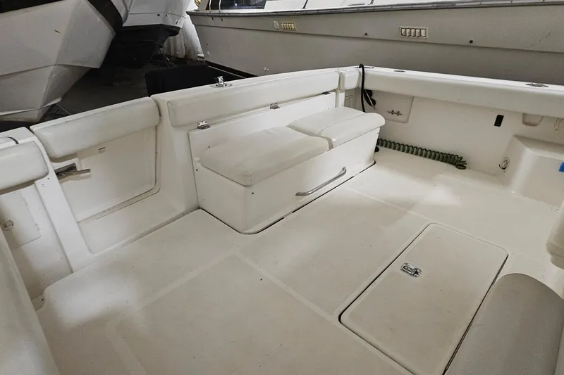 Slide: The Image of 2000 Tiara Yachts 3500 Open boat interior with white seating and storage compartments. - 5