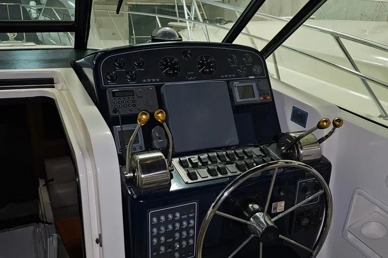 Slide: The Image of Control panel of a 2000 Tiara Yachts 3500 Open, featuring steering wheel and navigation instruments. - 8