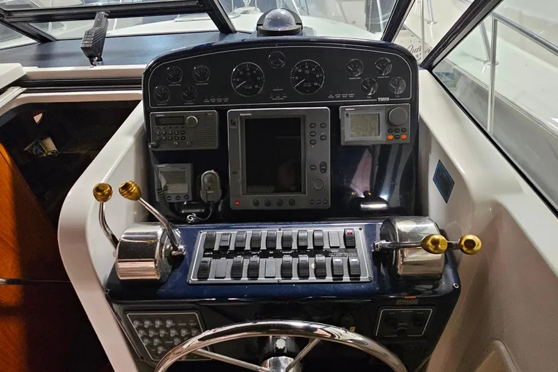 Slide: The Image of Cockpit of 2000 Tiara Yachts 3500 Open, featuring navigation and control instruments. - 9