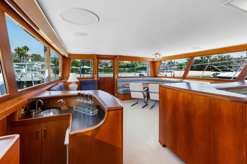 Slide: The Image of Luxurious interior of a 1983 Elliott Yacht Fisher, featuring elegant wood finishes and panoramic windows. - 10
