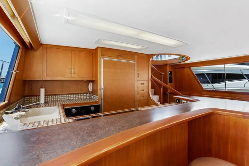 Slide: The Image of Interior of 1983 Elliott Yacht Fisher with wooden cabinetry and modern kitchen amenities. - 12