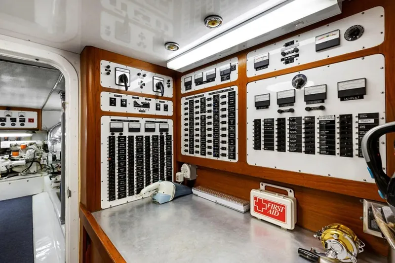 Slide: The Image of Control panel inside 1983 Elliott Yacht Fisher, featuring switches and gauges. - 14