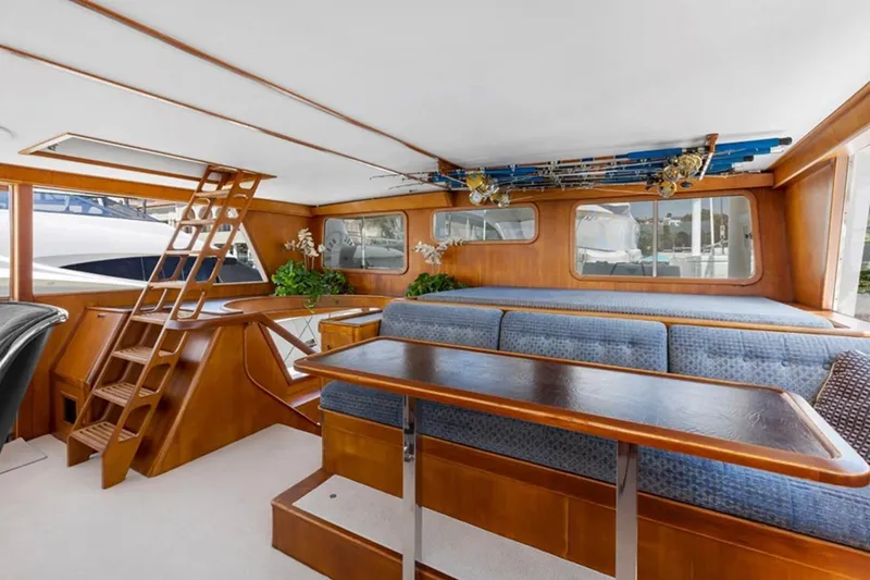 Slide: The Image of Interior of 1983 Elliott Yacht Fisher with wooden furnishings and fishing rods displayed. - 5