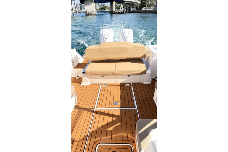 Slide: The Image of 2023 Robalo R317 Dual Console boat with dual engines and seating area. - 10
