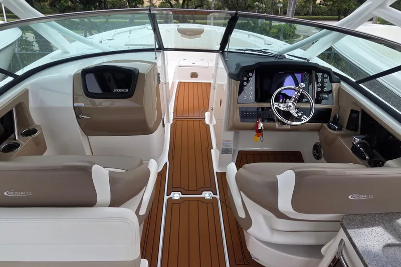 Slide: The Image of 2023 Robalo R317 Dual Console boat interior with teak flooring and seating. - 12