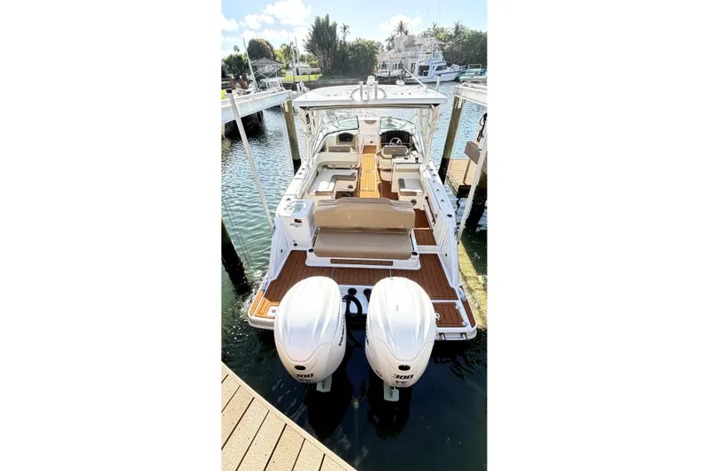 Slide: The Image of 2023 Robalo R317 Dual Console boat docked with twin engines, spacious seating. - 2