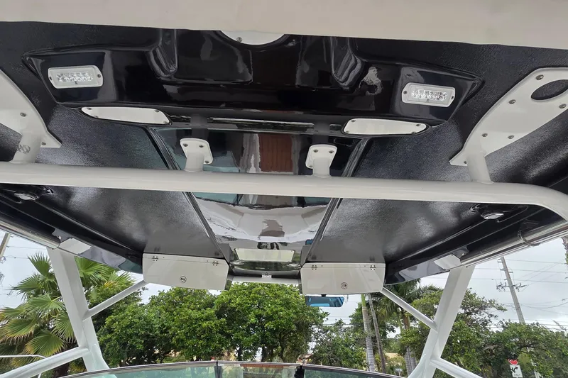 Slide: The Image of 2023 Robalo R317 Dual Console boat with open mini fridge, teak flooring. - 22
