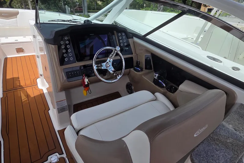 Slide: The Image of Control panel of 2023 Robalo R317 Dual Console boat with various switches and buttons. - 23