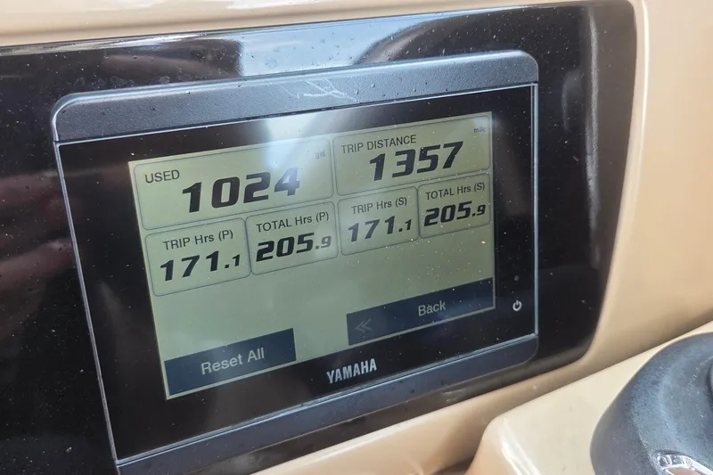 Slide: The Image of 2023 Robalo R317 Dual Console dashboard with Simrad navigation display and control buttons. - 27