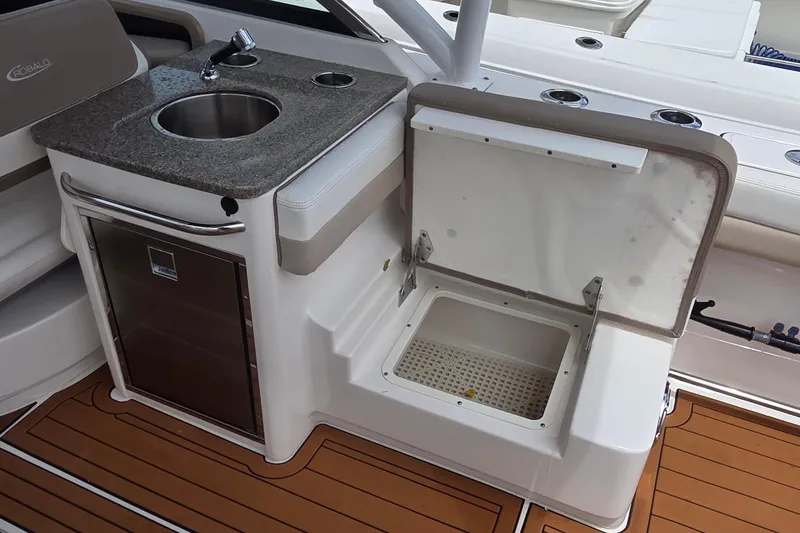 Slide: The Image of 2023 Robalo R317 Dual Console boat interior with Igloo cooler and storage compartment. - 32