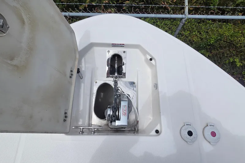 Slide: The Image of 2023 Robalo R317 Dual Console boat interior with sink, storage, and teak flooring. - 35