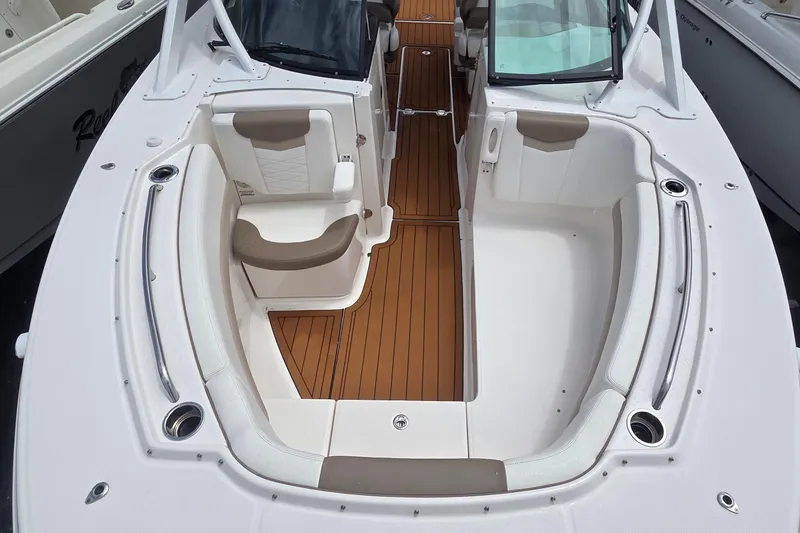 Slide: The Image of 2023 Robalo R317 Dual Console cabin storage area with clothing and gear. - 36