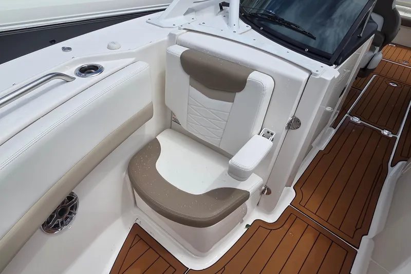Slide: The Image of 2023 Robalo R317 Dual Console helm with steering wheel and navigation controls. - 37