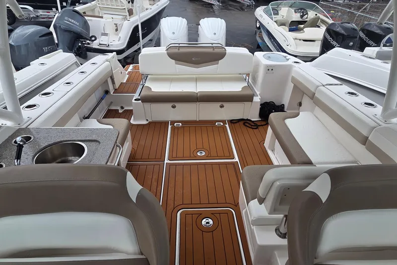 Slide: The Image of 2023 Robalo R317 Dual Console with twin Yamaha outboard engines on teak deck. - 9