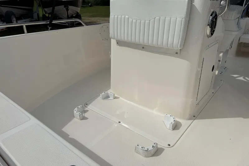 Slide: The Image of 2004 Sea Hunt Triton 186 boat interior with white seating and clean deck. - 13