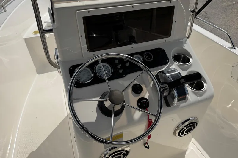 Slide: The Image of Steering console of a 2004 Sea Hunt Triton 186 boat with gauges and controls. - 15