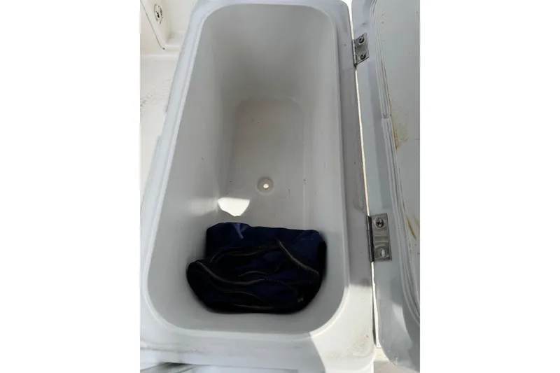 Slide: The Image of Open storage compartment on 2004 Sea Hunt Triton 186 boat. - 16