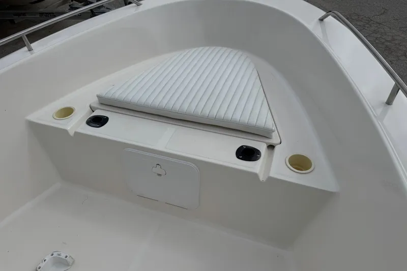 Slide: The Image of 2004 Sea Hunt Triton 186 boat interior with cushioned seating and cup holders. - 17