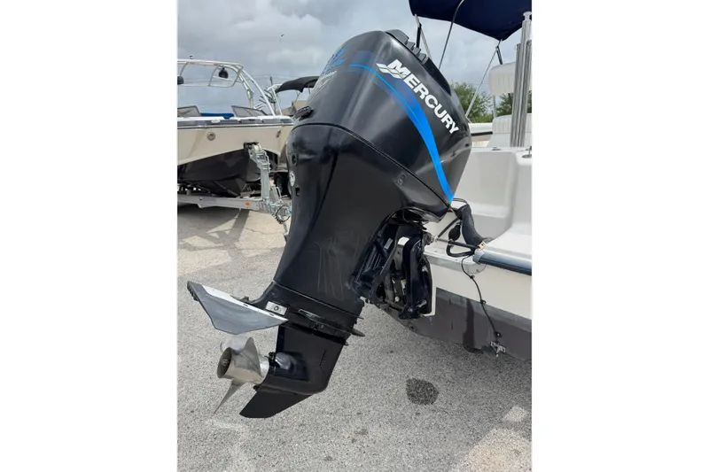 Slide: The Image of 2004 Sea Hunt Triton 186 with Mercury outboard motor, parked on a trailer. - 6